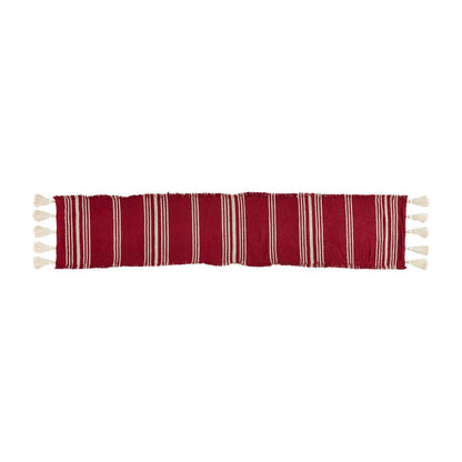 red and cream striped runner with cream tassels on the ends.