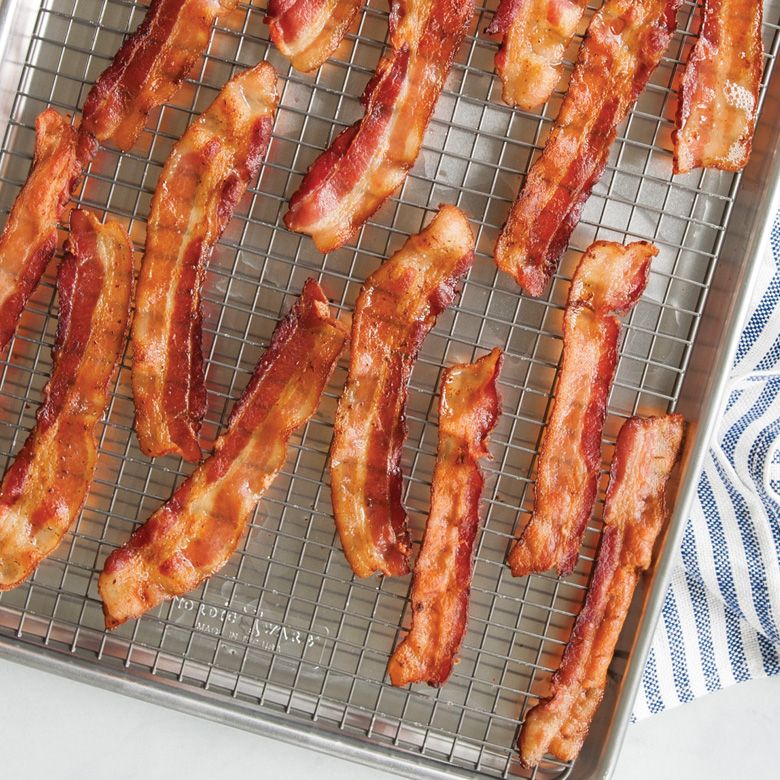 rack in baking tray with bacon on it.