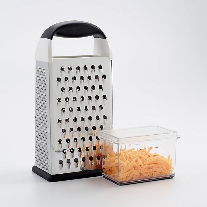 box grater with acrylic catch-cup detached, filled with grated cheese with lid on it.