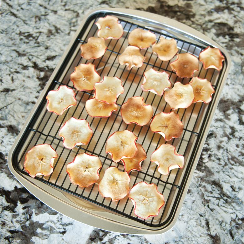 baking tray with apple slices on rack.