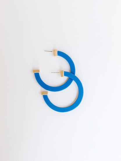 royal hoop earrings with gold ends on a white background.