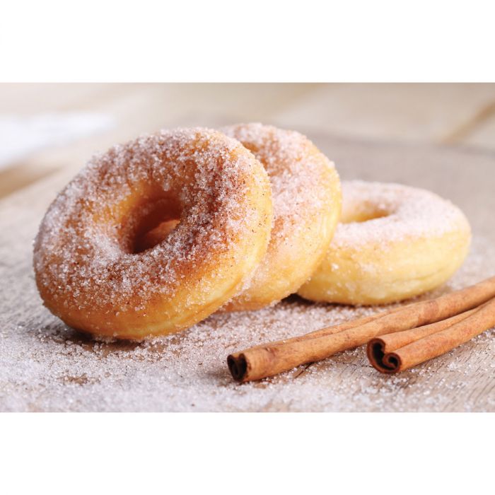 a display of donuts with cinnamon sticks on a sugar dusted surface