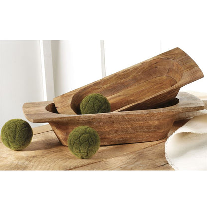 small and large mango wood dough bowls displayed with moss balls on a wooden table