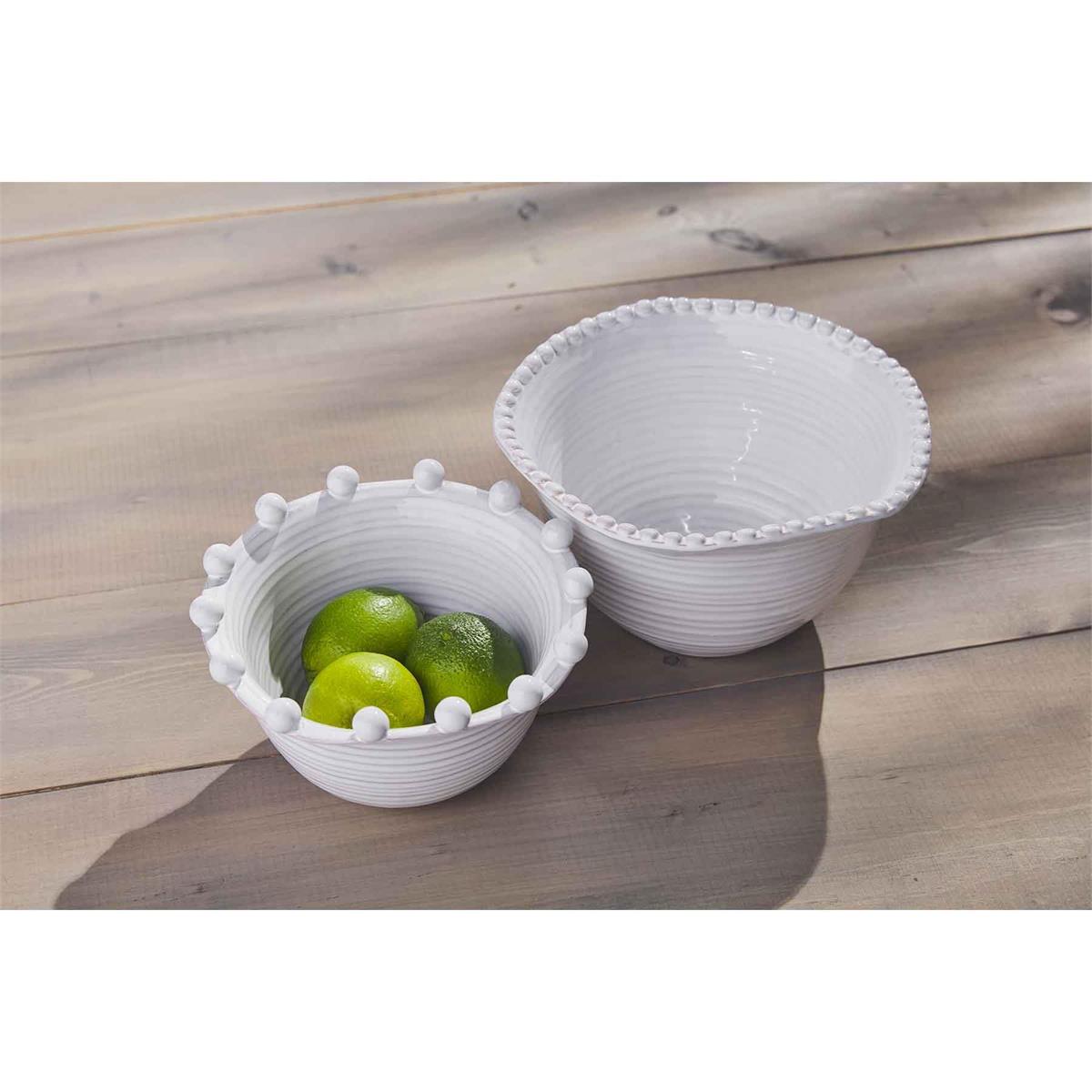 small and large beaded side bowls with limes displayed on a medium stain wood slat table