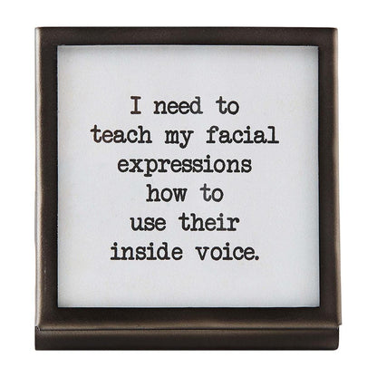 facial expression black metal framed saying on a white background