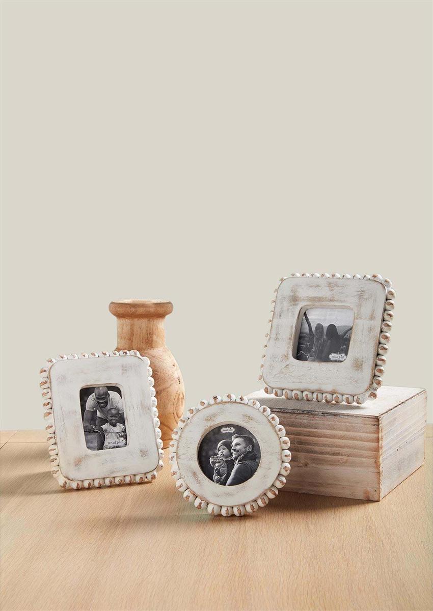 all three styles of small white beaded frames displayed with a wooden box, wooden vase on a wooden table