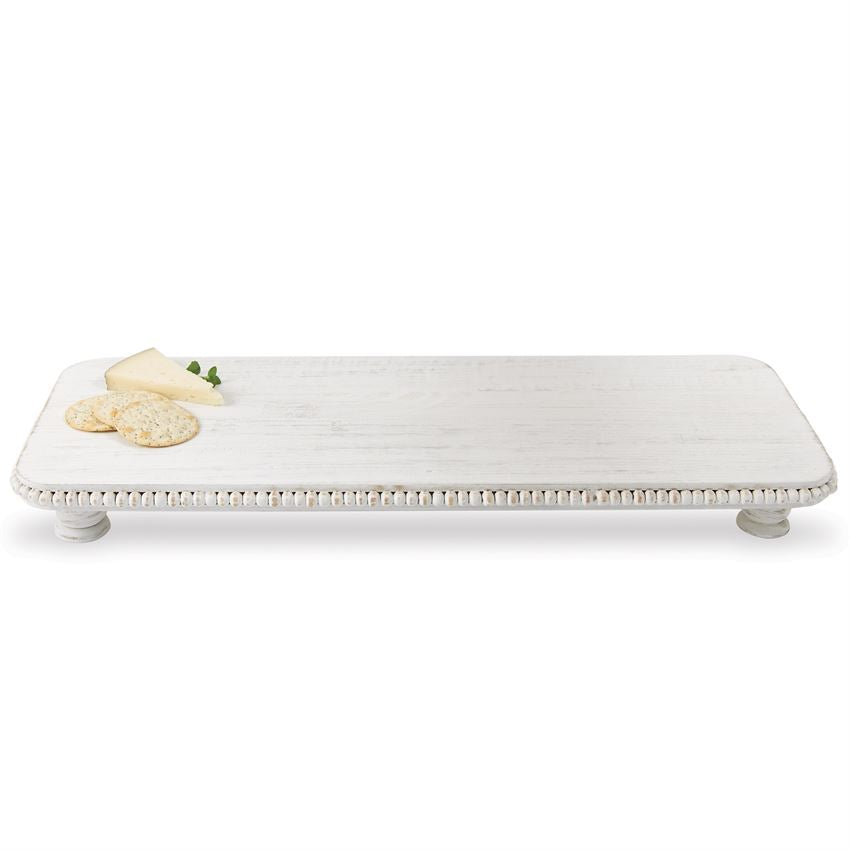 large beaded wood serving board with crackers and cheese on a white background