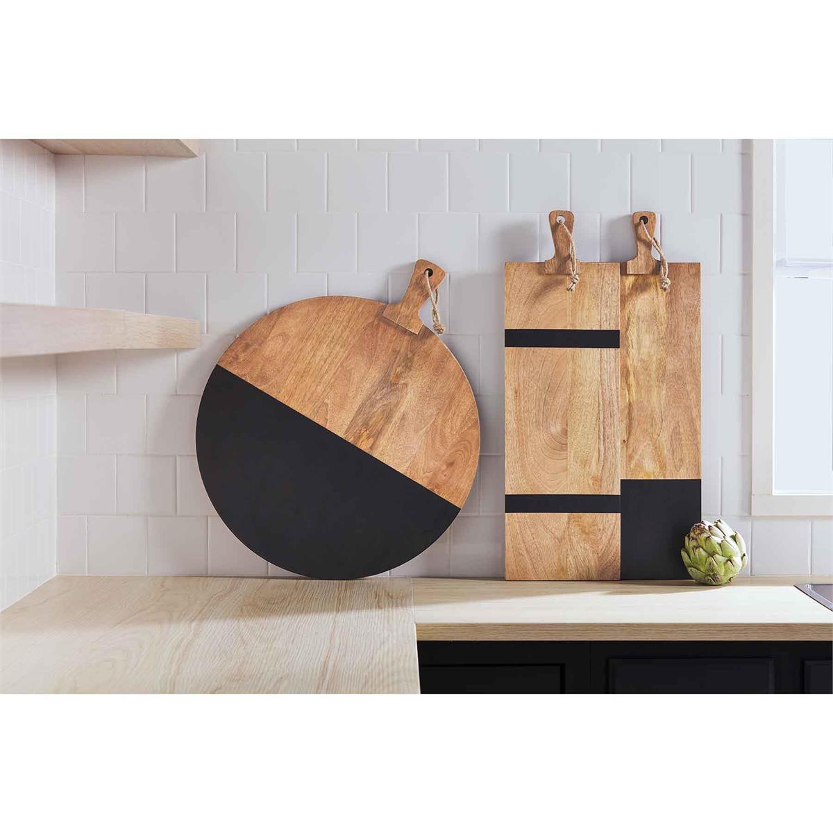 all three styles of black and natural wood boards displayed on a kitchen counter against a white backsplash 
