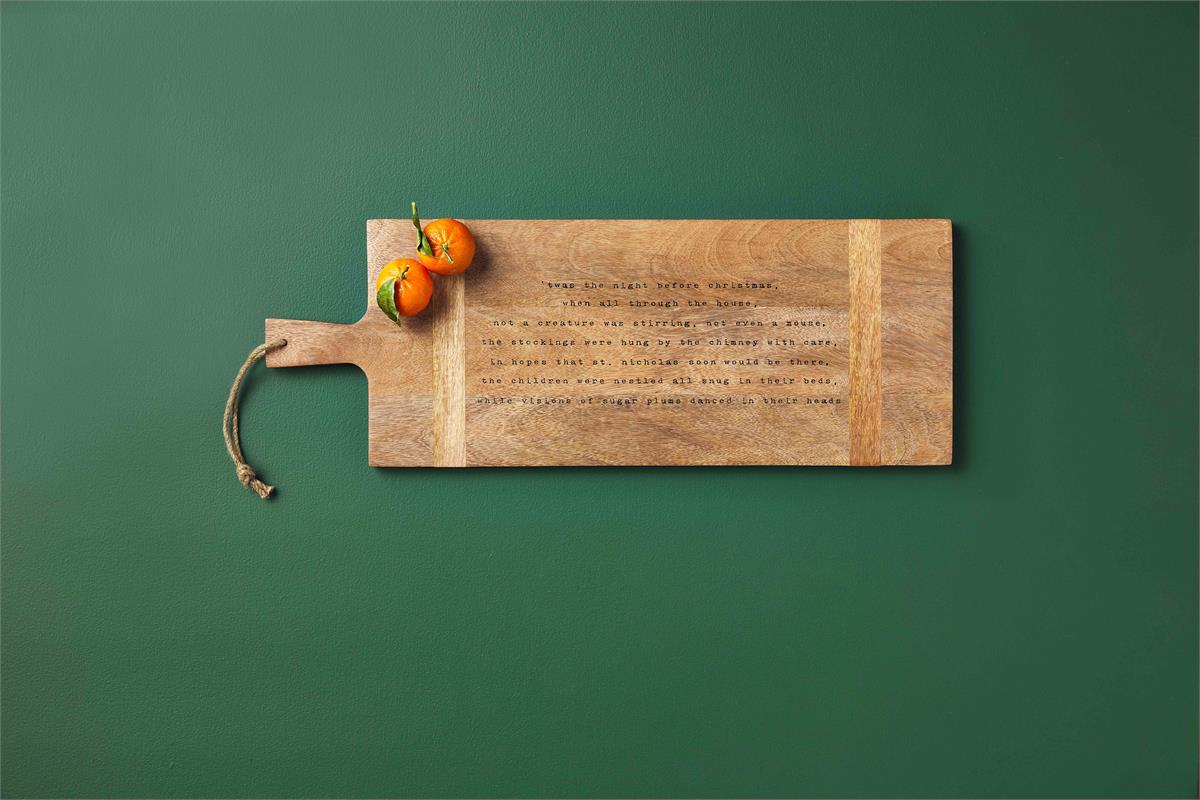 wooden board with 2 clementines on it on a green background.