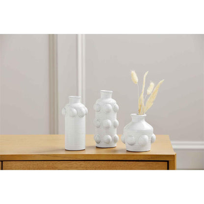 all three sizes of raised dot bud vases on a wooden hall table