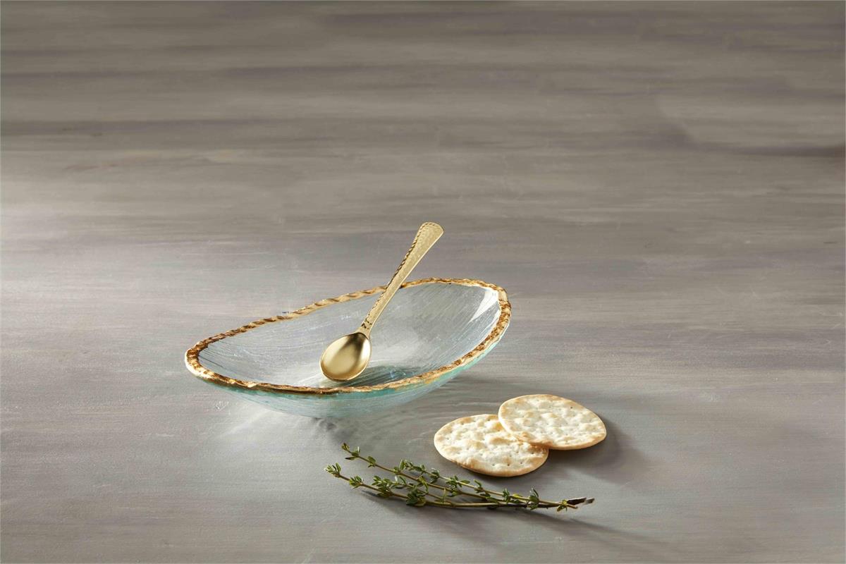 gold edge dip bowl and spoon set displayed next to crackers and sprig of spices on a gray surface
