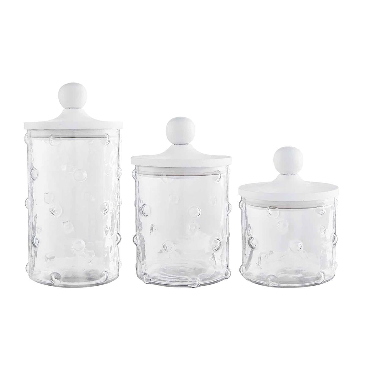 all three sizes of hobnail canisters are clear glass with glass dots and white wooden lids against a white background