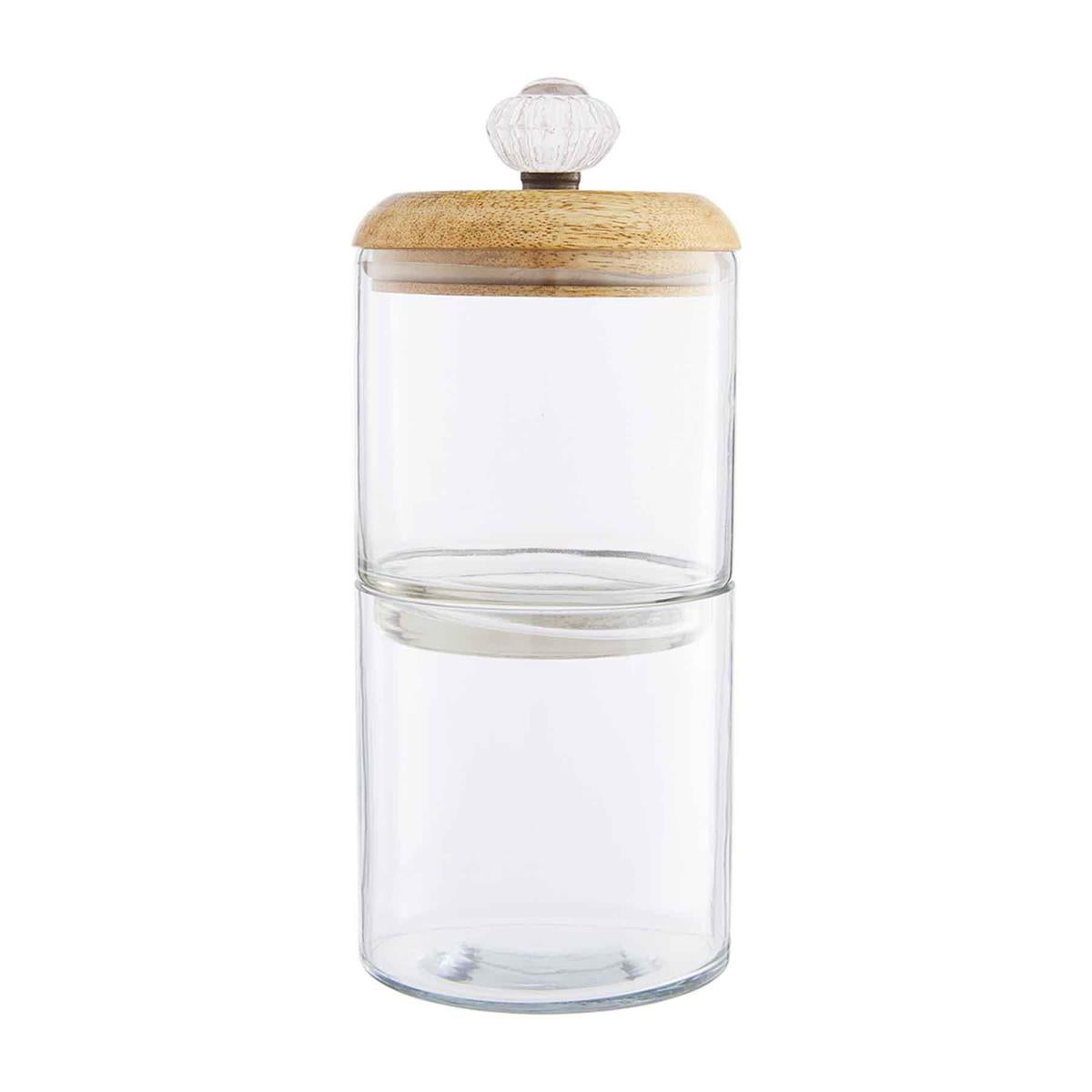 two clear glass stacked jars with a wooden lid and glass door knob on a white background