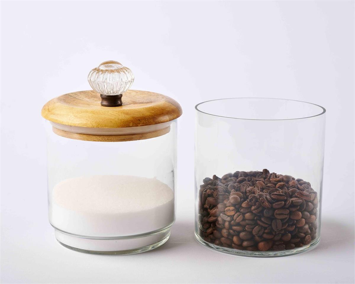 door knob storage jars displayed separately with the lid on one. one partially filled with sugar, and one with coffee beans on a light gray background
