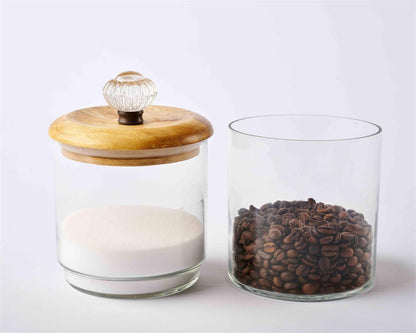 door knob storage jars displayed separately with the lid on one. one partially filled with sugar, and one with coffee beans on a light gray background