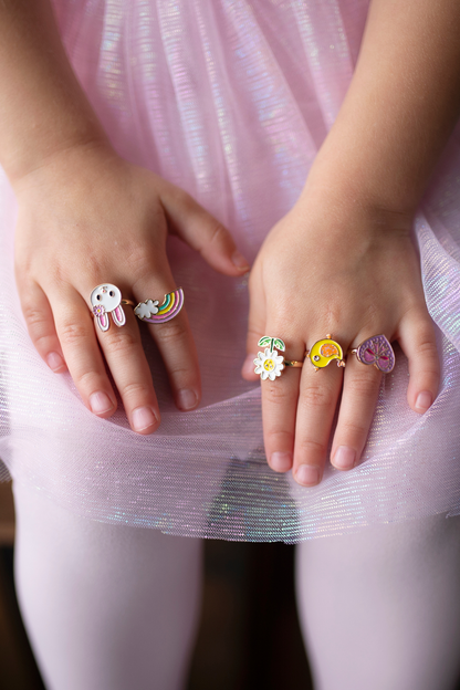 the spring flower rings set displayed on a little girls hands