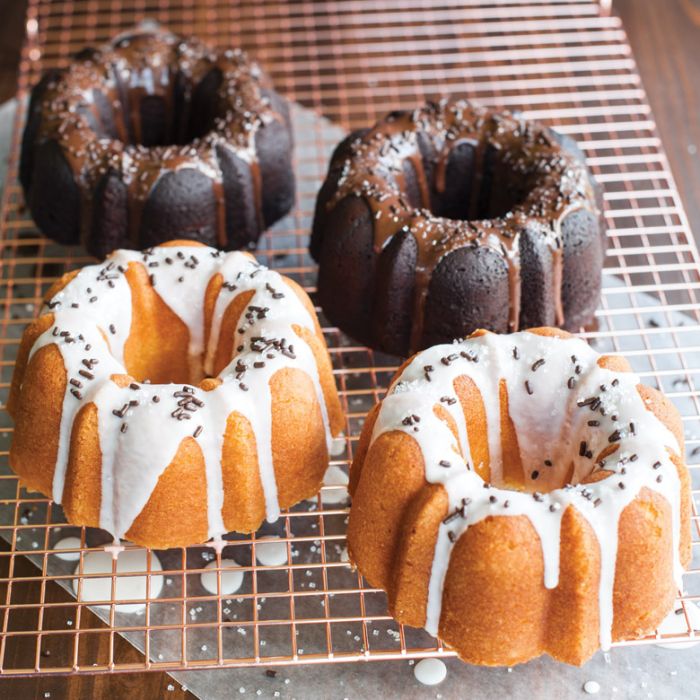small bundt cakes on cooling rack drizzled with glaze and sprinkles.
