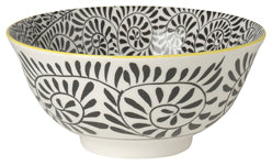 white ceramic bowl with black swirl pattern inside and out and a yellow rim.
