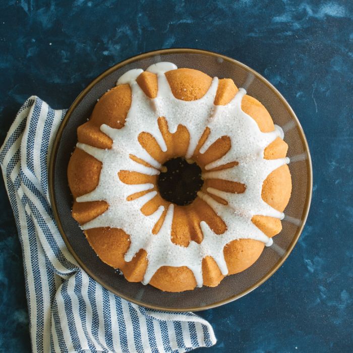 top view of bunt cake on tray with glaze.