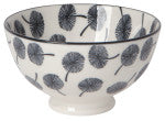 white ceramic bowl with black flower design inside and out.