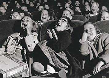 front of card photograph of girls laughing in a movie theater 