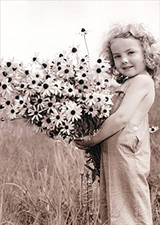 front of card is photograph of a young girl holding an arm full of daisies