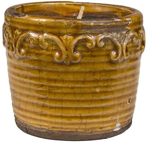 short round candle in orange canister with distressed finish.