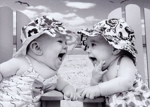 front of card is a photograph of laughing babies on the beach