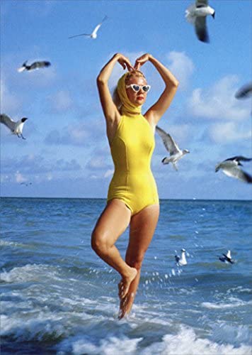 front of card is a photograph of a woman wearing a full bathing suit in the ocean with sea gulls 