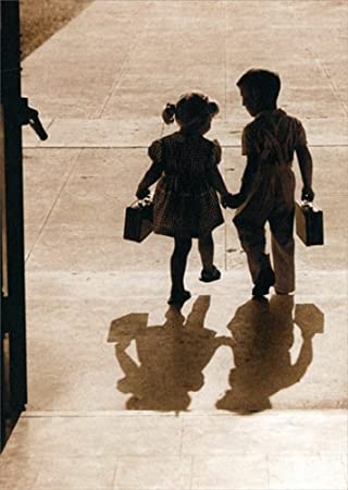 black and white photograph of young children leaving school holding hands