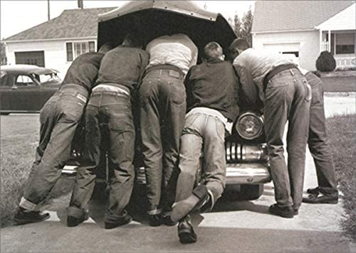 front of card is a photograph of six men leaning under the hood of an old car