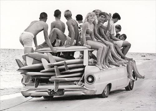 front of card is a photograph of a car full of surf boards and surfers sitting on top of car