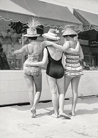 front of card is a black and white photograph of three women walking arm in arm away from the camera