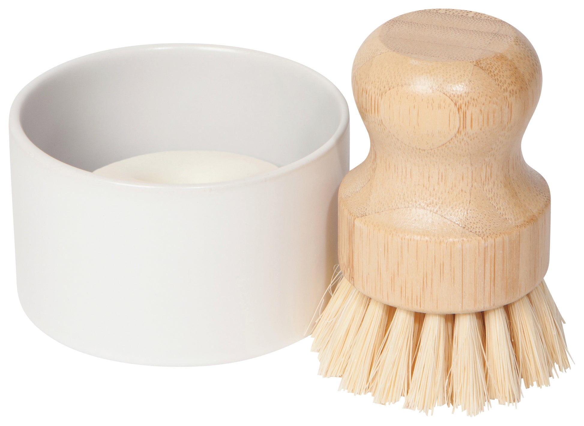 wooden handled scrub brush with white ceramic holder next to it on a white background.
