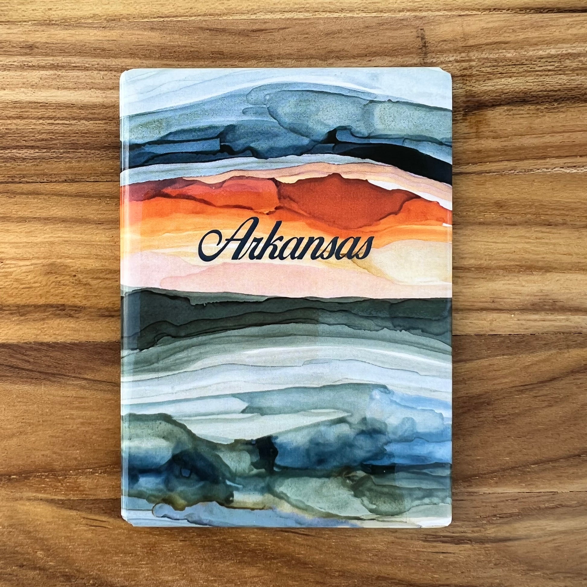 magnet with abstract sunrise image and "arkansas" printed on it.