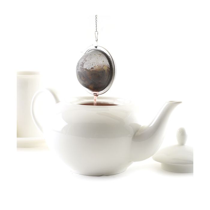 tea infuser filled with tea dripping over teapot.