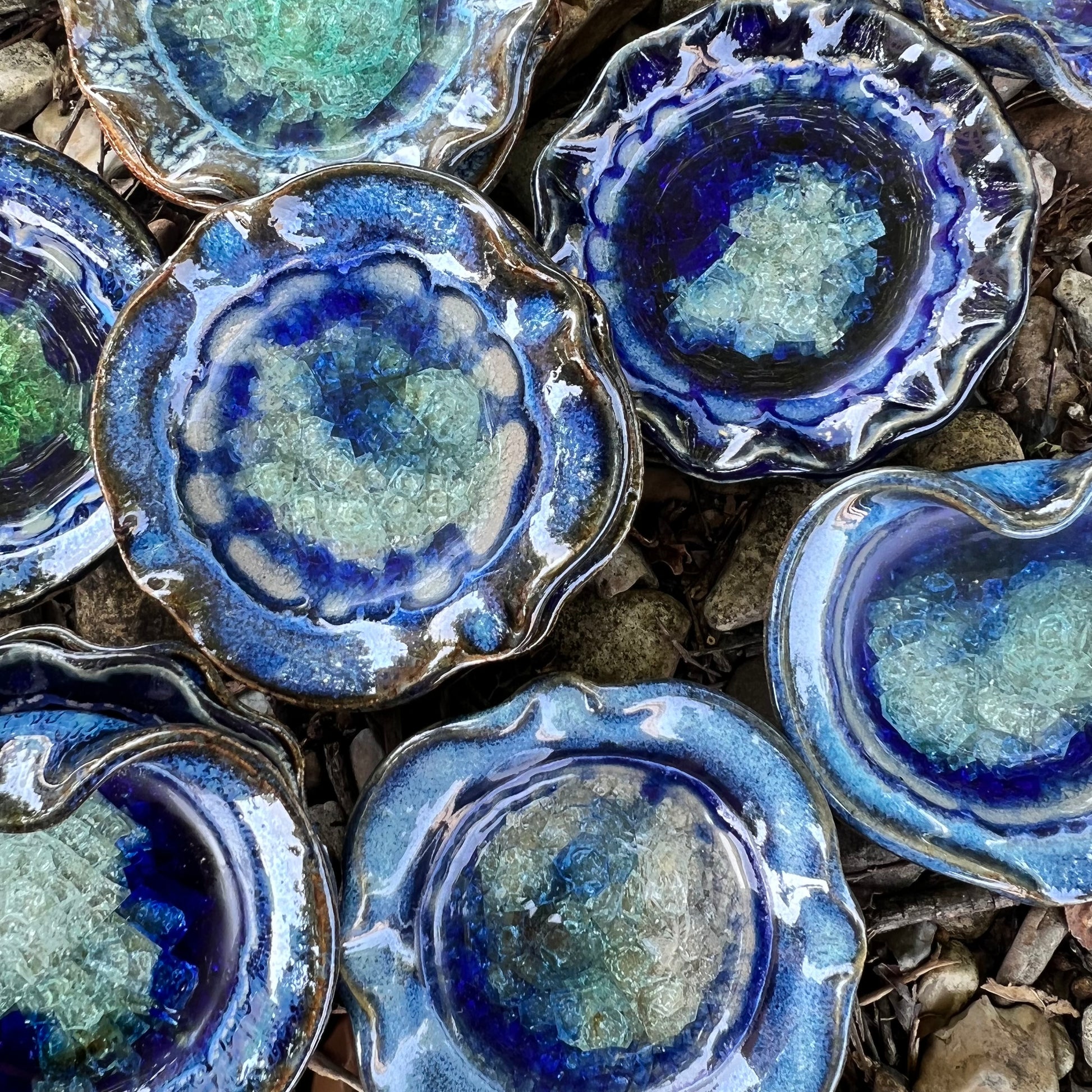 beautiful blues  heart and round crackled glass displayed on leaves and rocks