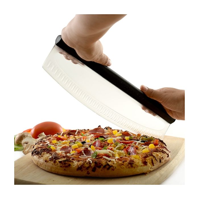 hands holding pizza slicer on pizza.