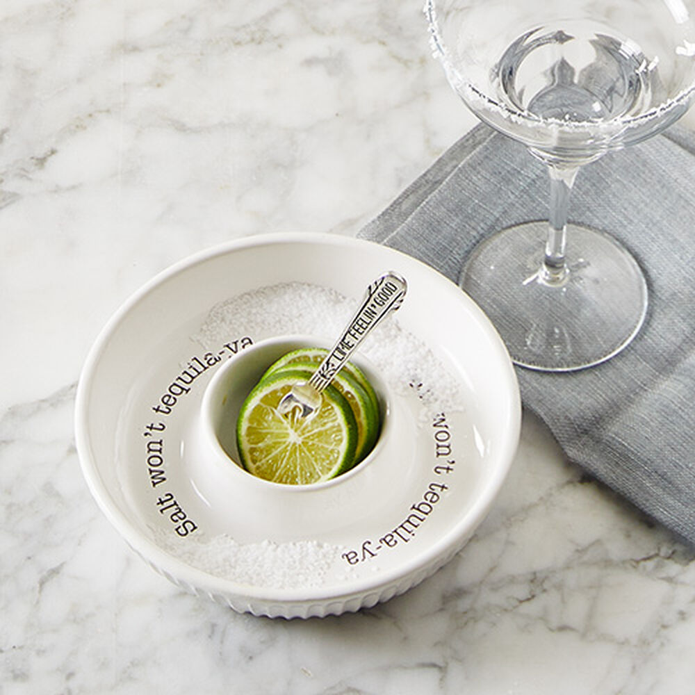 salt rimmer and lime set displayed next to a margarita glass and gray towel on a white marble surface