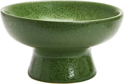 green stoneware footed bowl on white background.