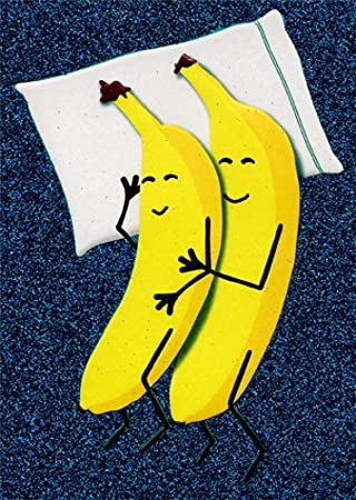 front of card is a drawing of two bananas spooning on a bed with one pillow