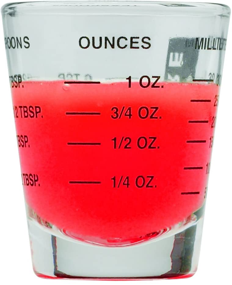 the mini measuring glass filled against a white background