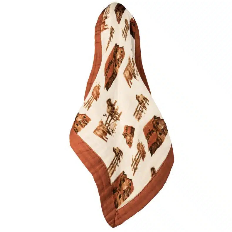 cream lovey with brown boarder and all-over pattern of barns, horses, and cows.