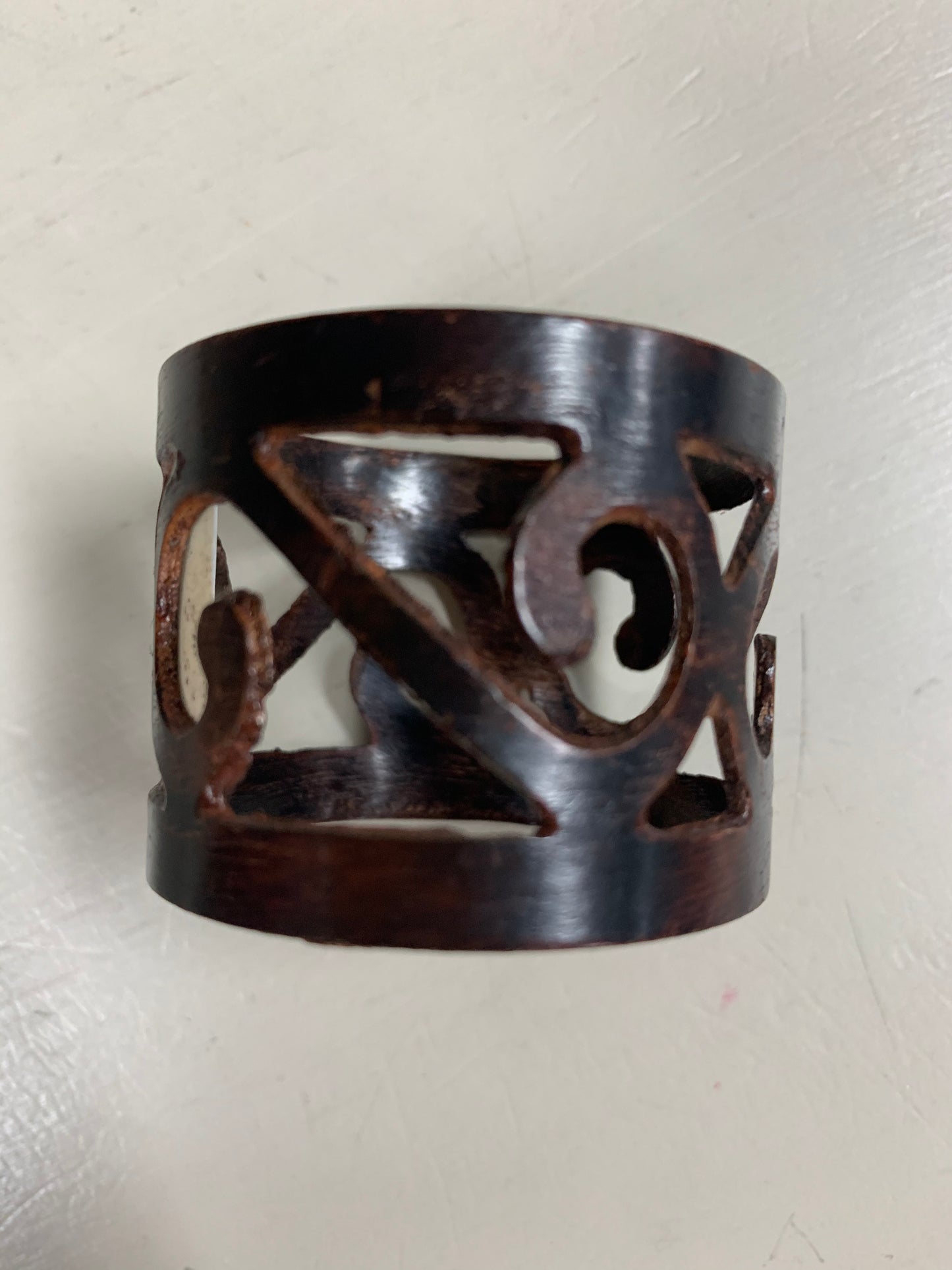 napkin ring with scroll pattern and a bronze finish.