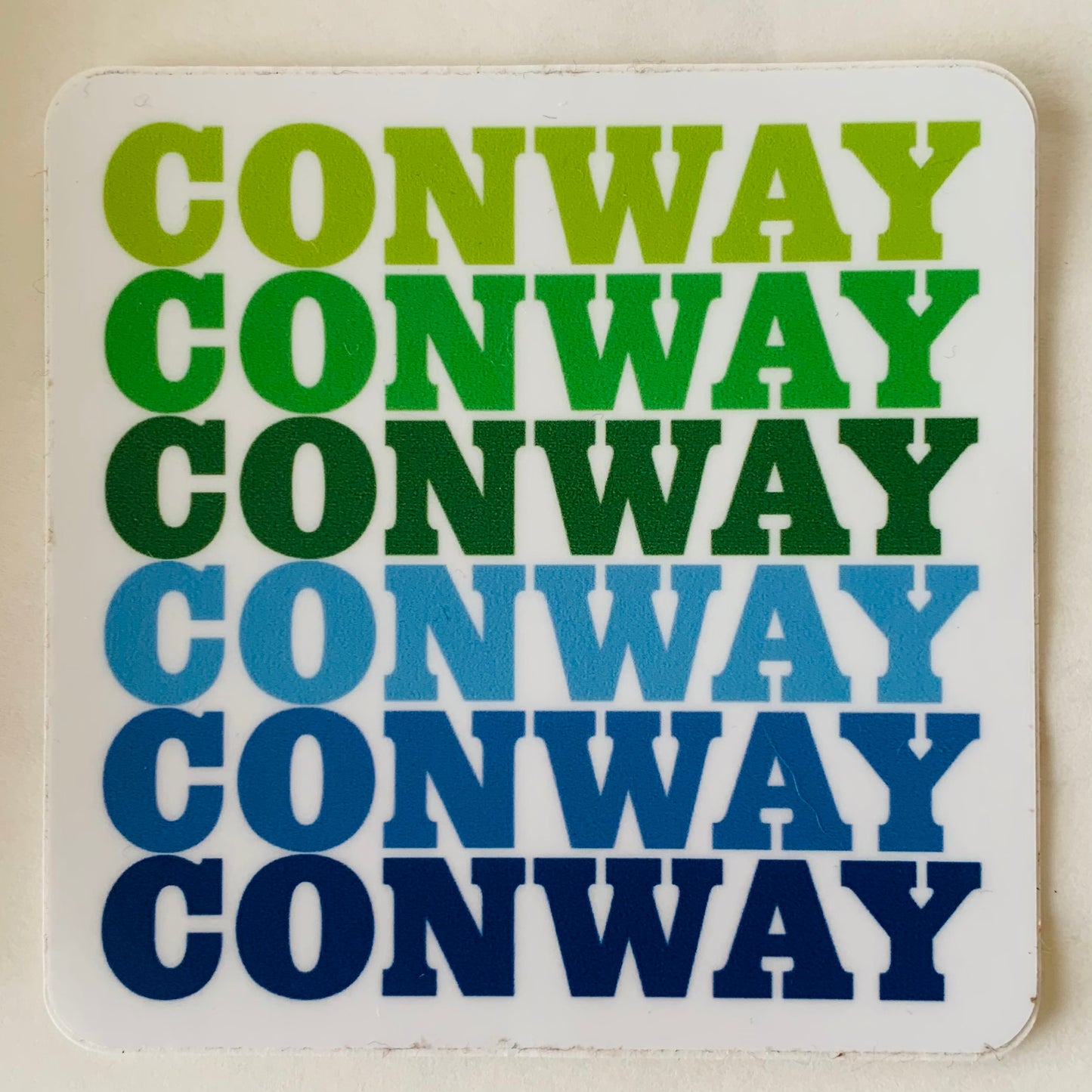 sticker with "conway" written six times with green to blue Ombre coloring.