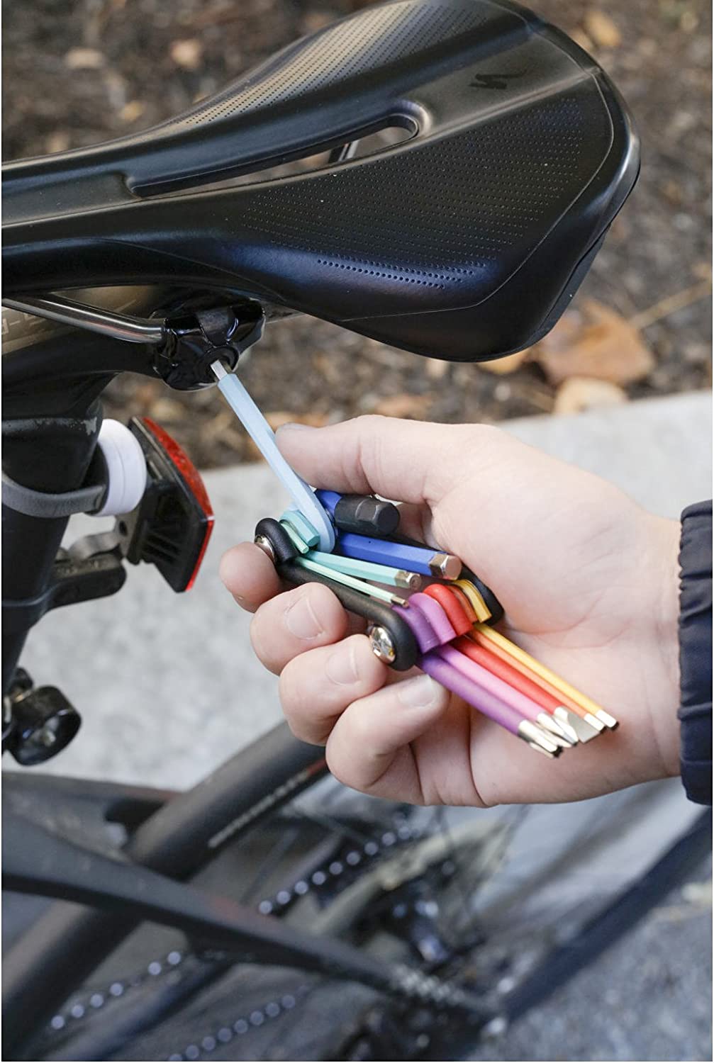 illustration of a person using the rainbow multi tool on a bicycle outside