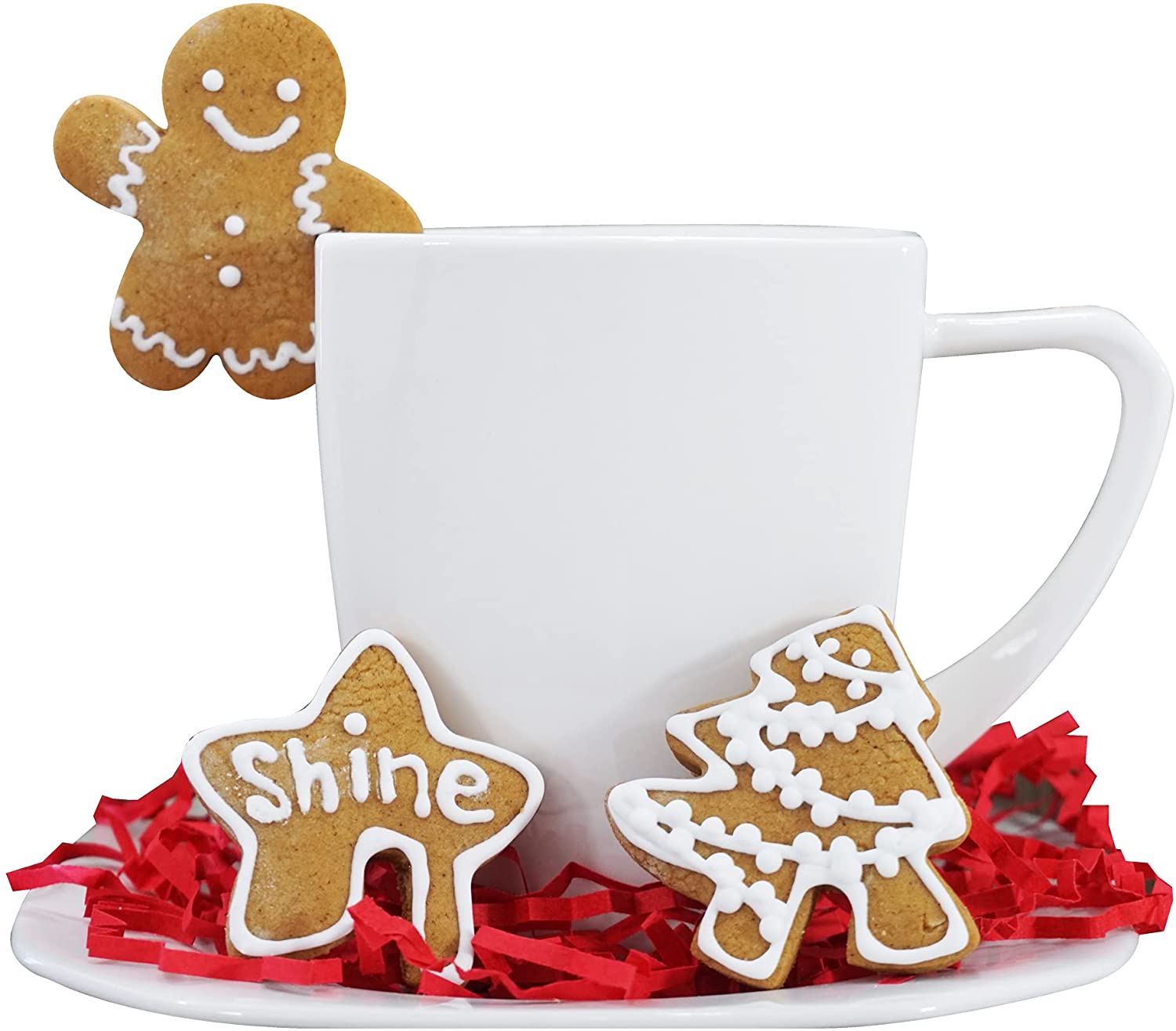 2 cookies set next to a white mug and a gingerbread man cookie hanging over the edge of the mug.