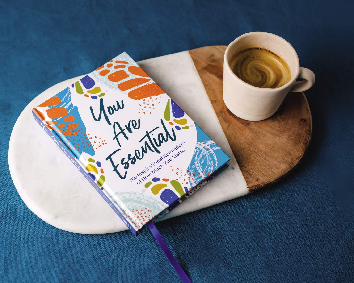 book laying on a tray with cup of coffee