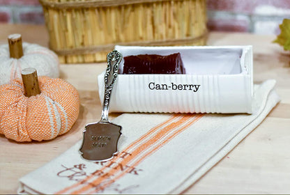 white ceramic dish shaped like a can with "can-berry" in black and silver server.