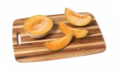 teak oversized cutting board displayed with a cut melon on a white background